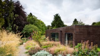 Image may contain Outdoors Plant Nature Building House Cottage Housing Vegetation Shelter Countryside and Rural