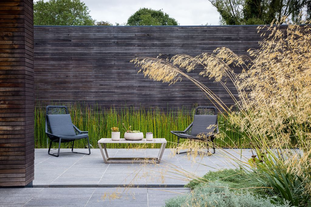 Image may contain Yard Outdoors Nature Furniture Chair Patio Backyard Table Flagstone Tree Plant and Couch