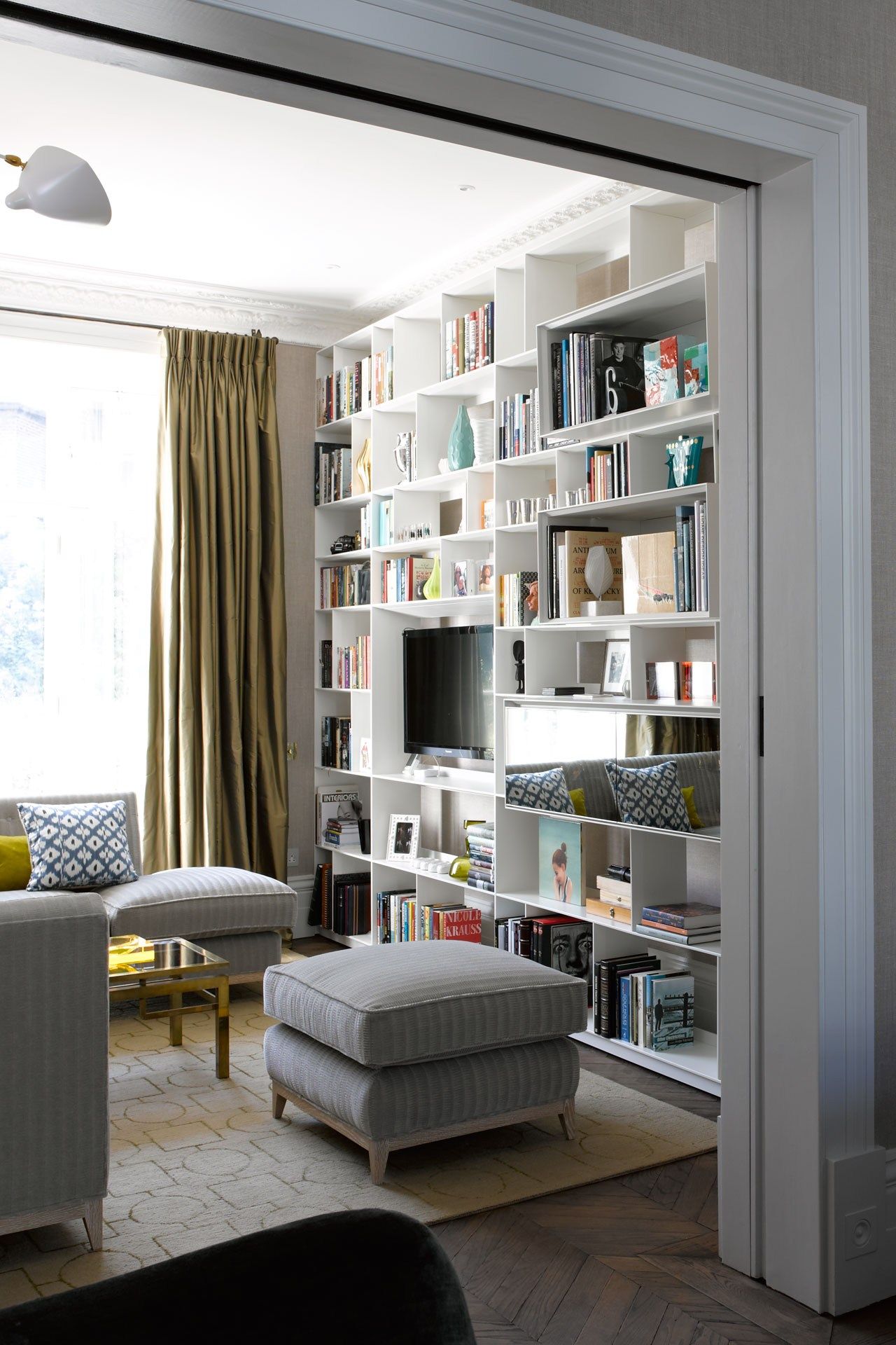 Image may contain Shelf Furniture Bookcase and Rug
