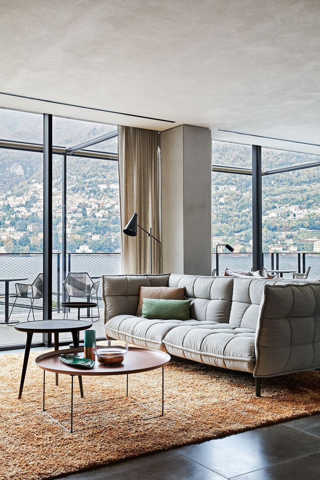 Image may contain Furniture Table Coffee Table Rug Indoors Housing Building Living Room Room Tabletop and Couch