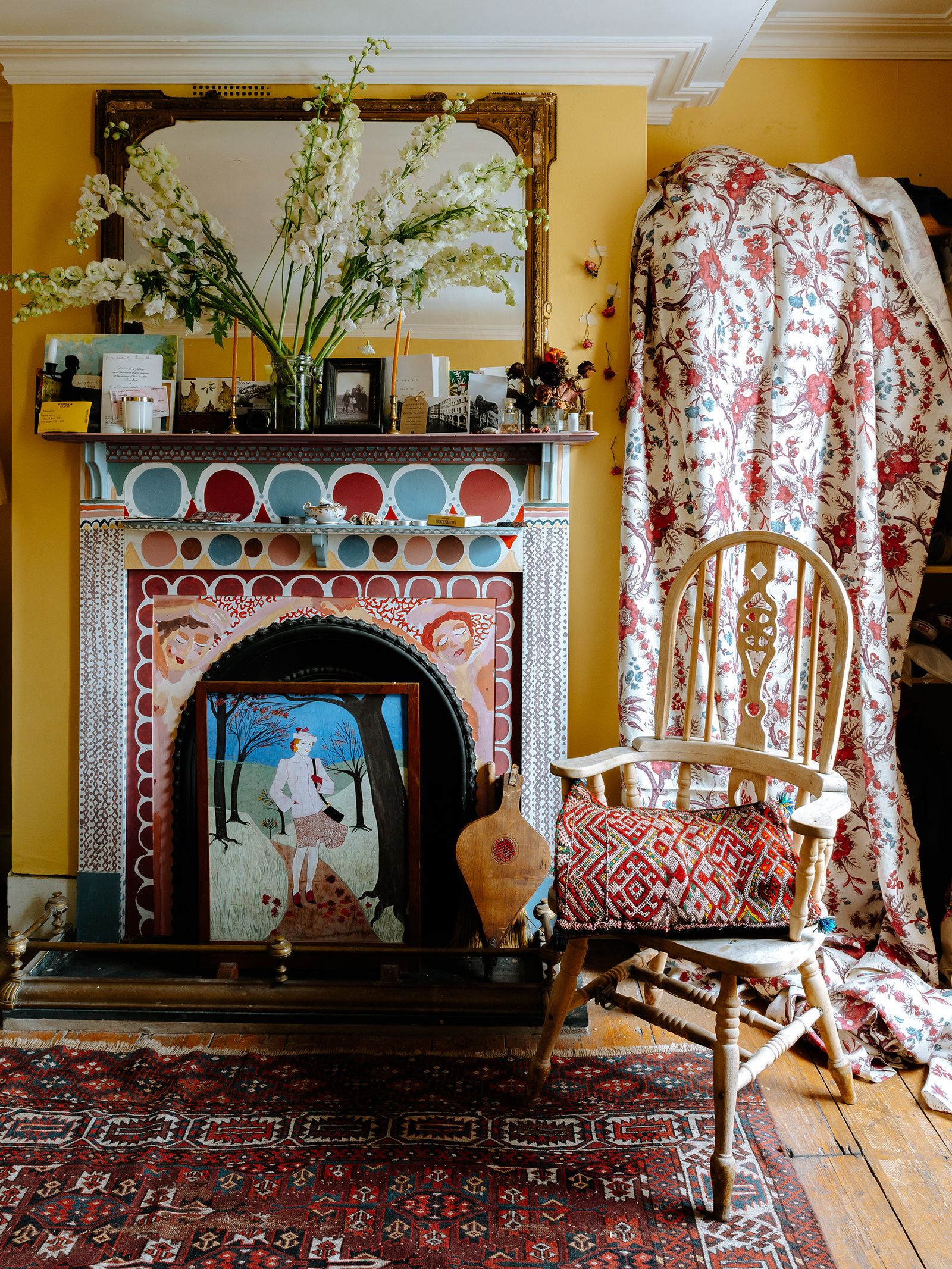 To similarly charming effect a fireplace has been painted by hand with a design in the bedroom of the same house.
