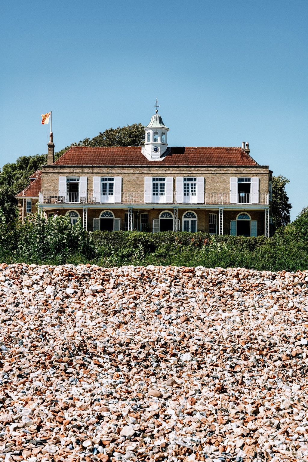 The back of the house seen from the pebbly beach a nature reserve that is home to many rare nesting birds.