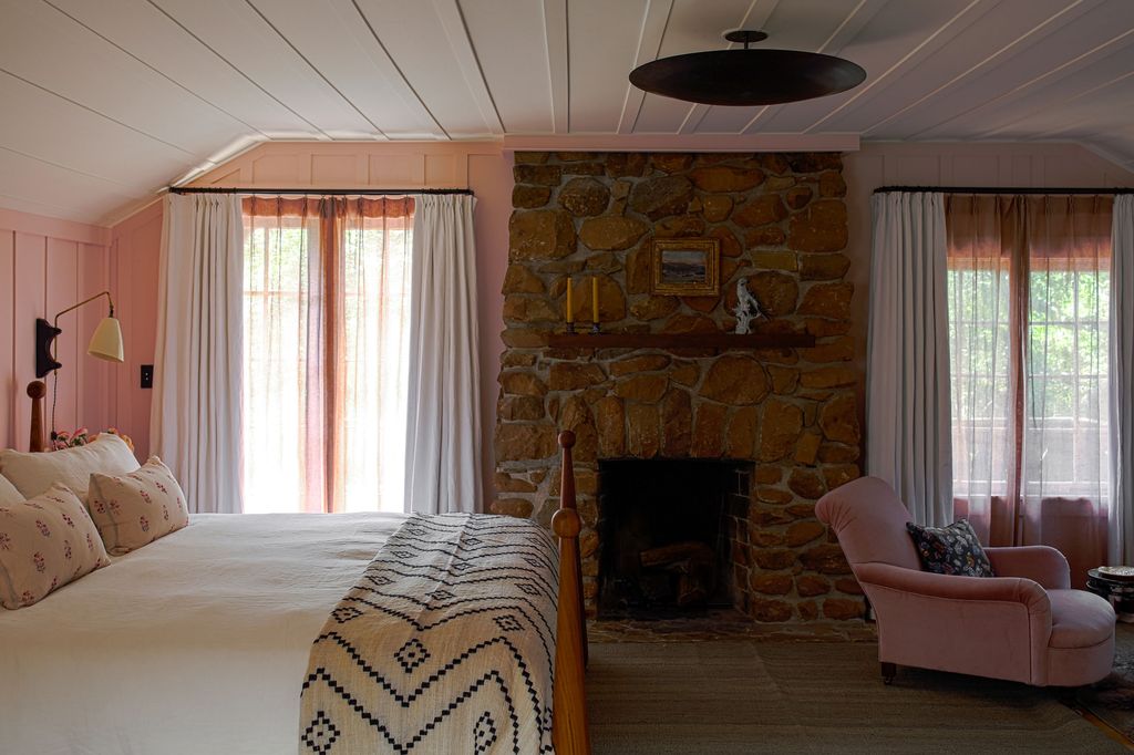 Image may contain Indoors Furniture Room Living Room Fireplace Bed Hearth Couch and Interior Design