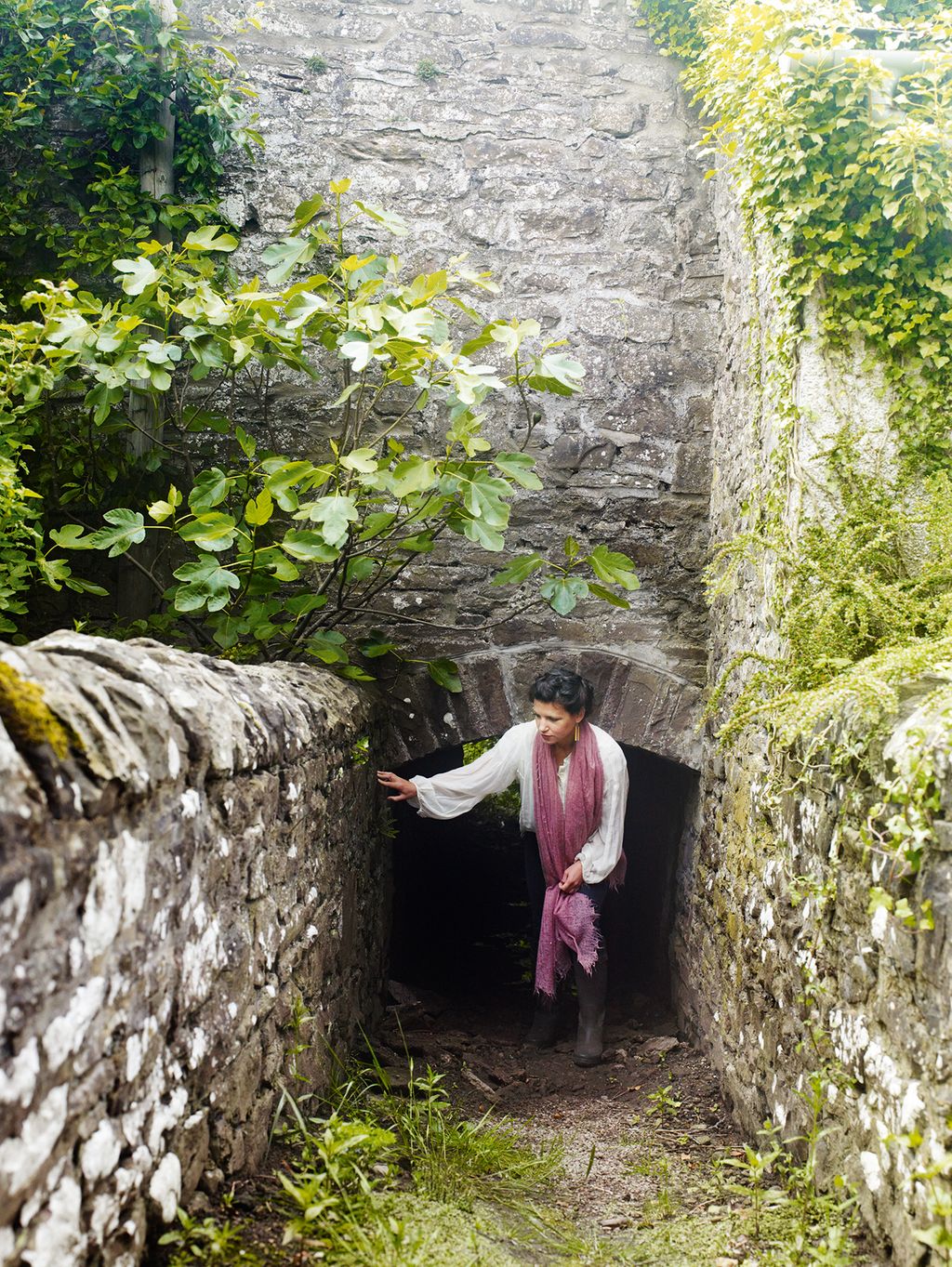 Image may contain Path Walkway Human Person Wall Clothing Apparel Outdoors Slate Bunker Building Rock and Plant