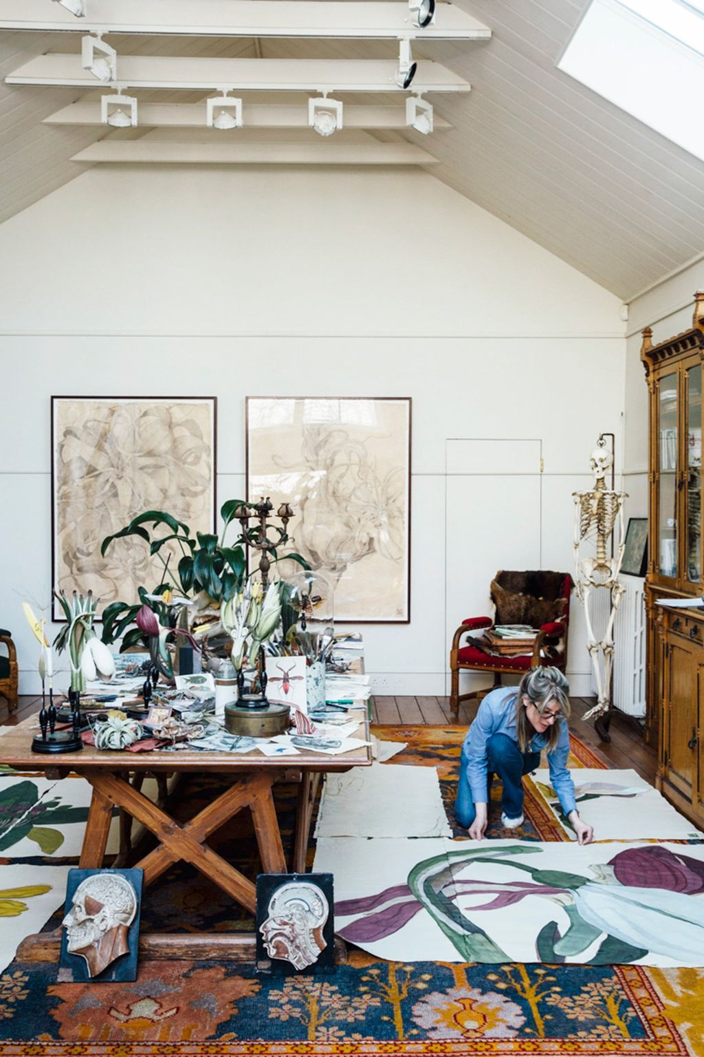 Image may contain Furniture Living Room Indoors Room Table Human Person Dining Table Tabletop Clothing and Shoe