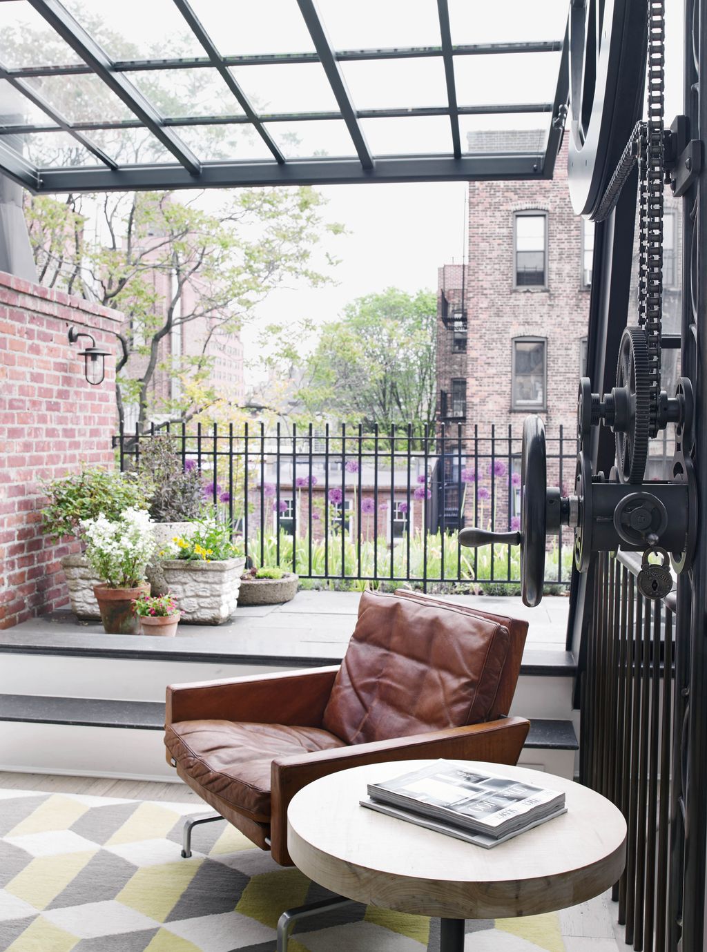 Added on top of the original roof Jos's office has access to the terrace the side table is BDDW's 'Cannon' design.