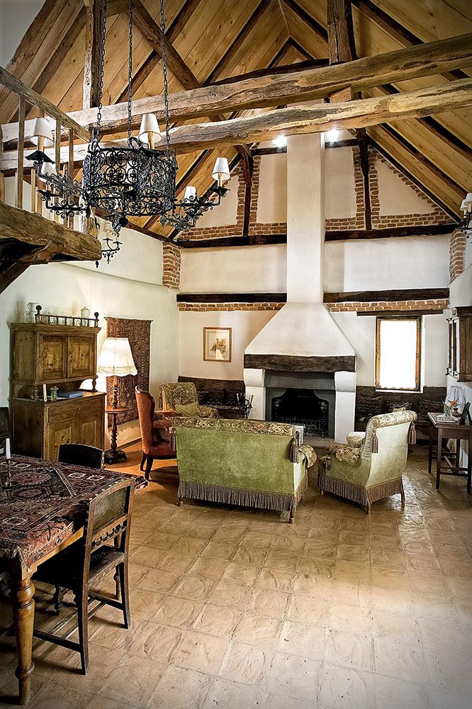 Image may contain Loft Housing Building Indoors Wood Living Room Room Flooring Furniture Couch and Interior Design