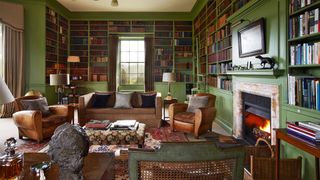 Image may contain Living Room Room Indoors Furniture Couch Interior Design Chair Hearth Fireplace and Electronics