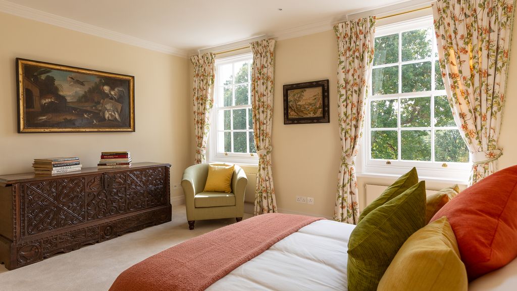 Image may contain Furniture Room Indoors Living Room Interior Design Bedroom Couch Flooring Wood and Bed