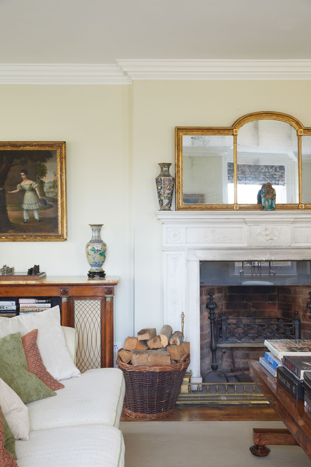 Image may contain Indoors Living Room Room Furniture Fireplace Interior Design Hearth Human and Person