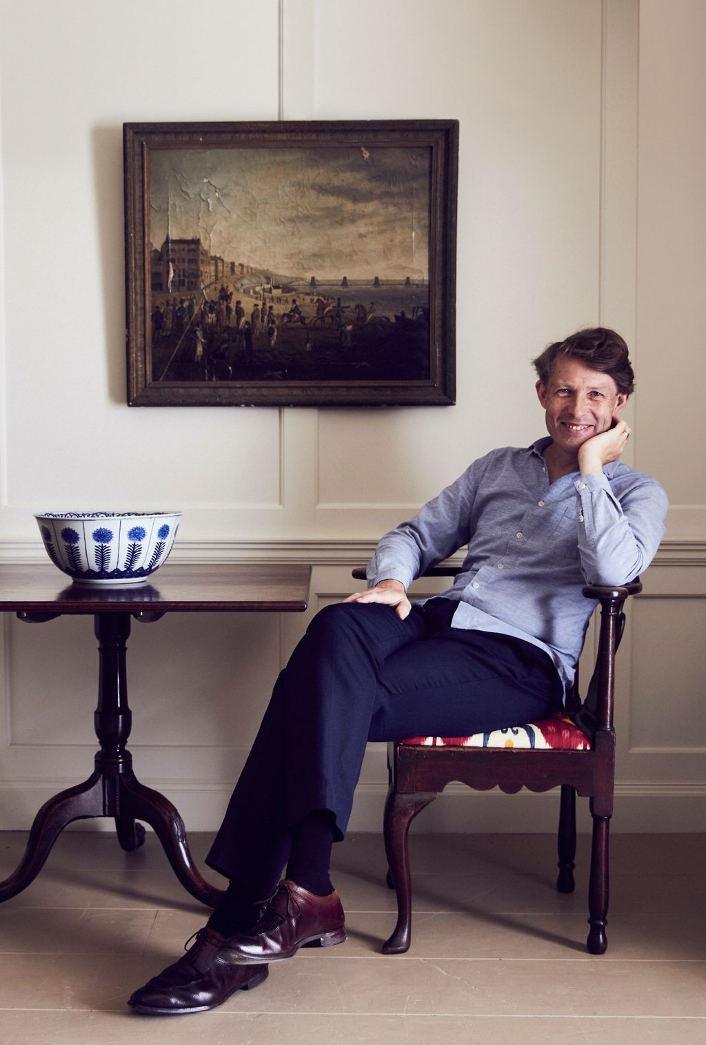 Image may contain Furniture Chair Sitting Human Person Clothing Apparel Footwear Shoe and Flooring