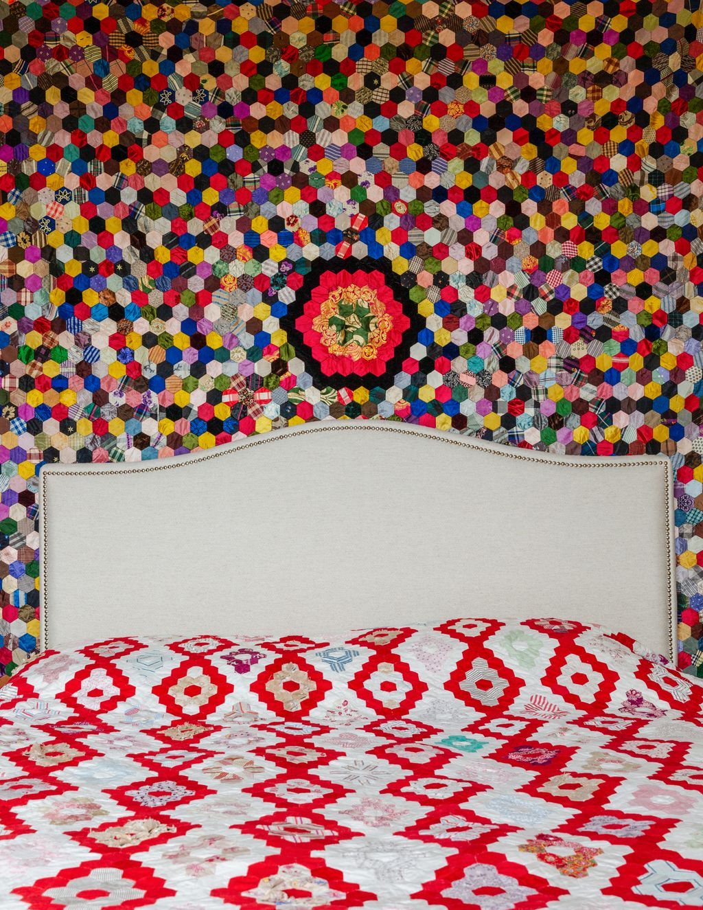 The guest bedroom has an antique silk patchwork bought from The Alleyways Antiques Market in Bridport on the wall and a...