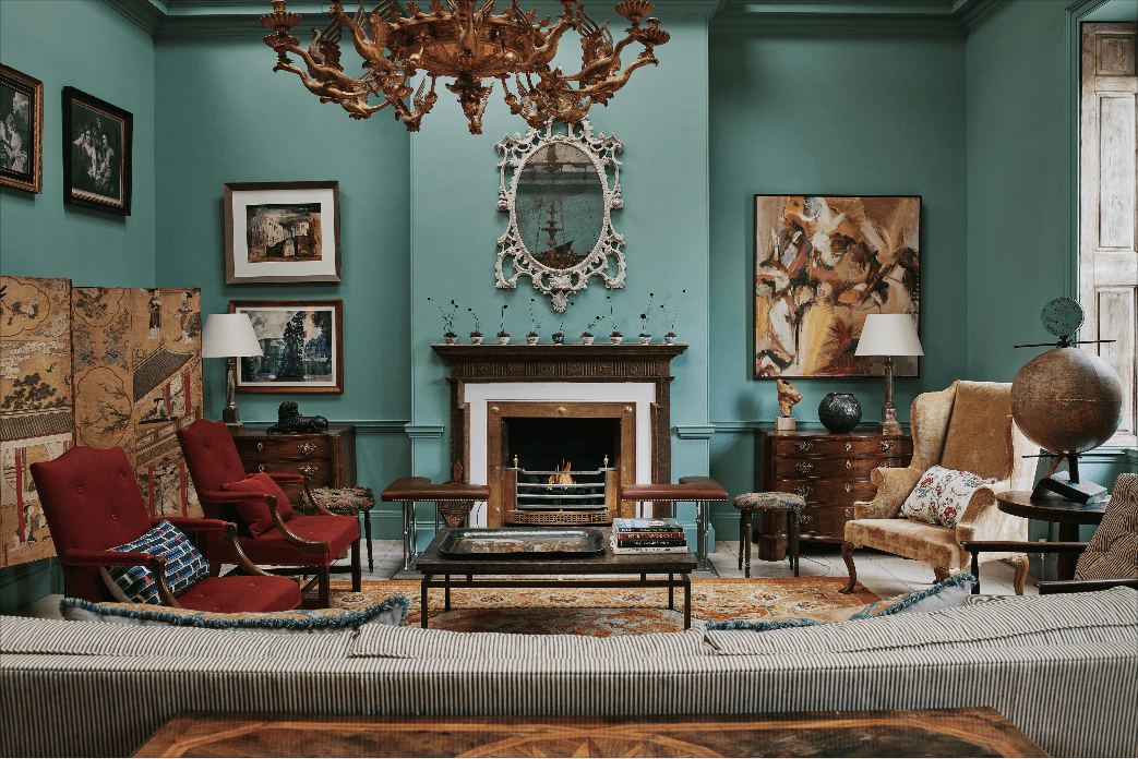 Image may contain Living Room Room Indoors Furniture Couch Chair Interior Design Hearth Fireplace and Table