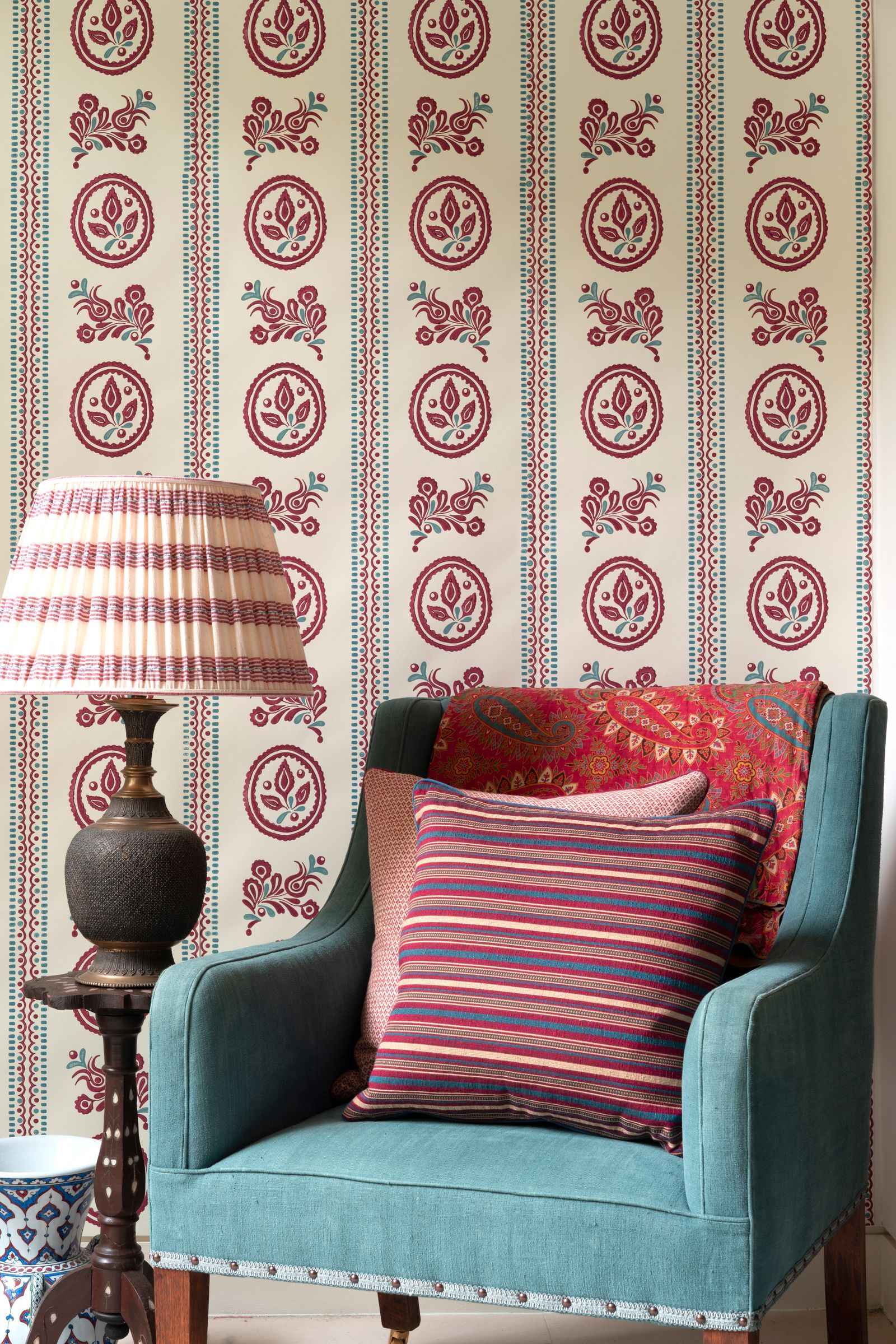 Image may contain Furniture Chair Lamp Table Lamp Couch Living Room Indoors Room and Cushion