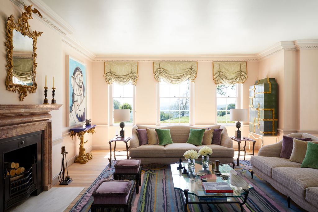 Image may contain Furniture Living Room Indoors Room Couch Table Interior Design Flooring Coffee Table and Rug