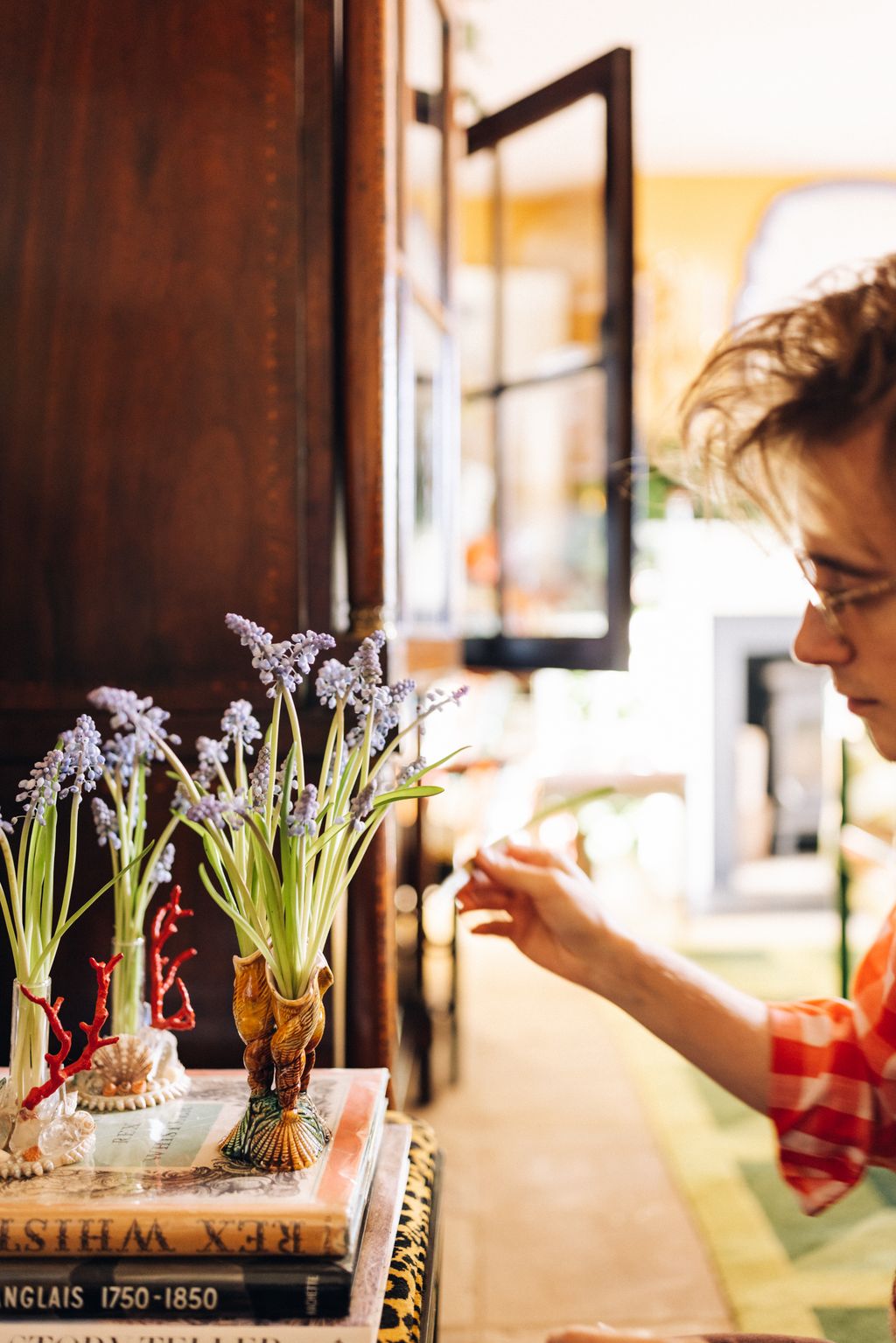 Image may contain Human Person Plant Flower Blossom Flower Arrangement Art Pottery Ikebana Ornament Vase and Jar