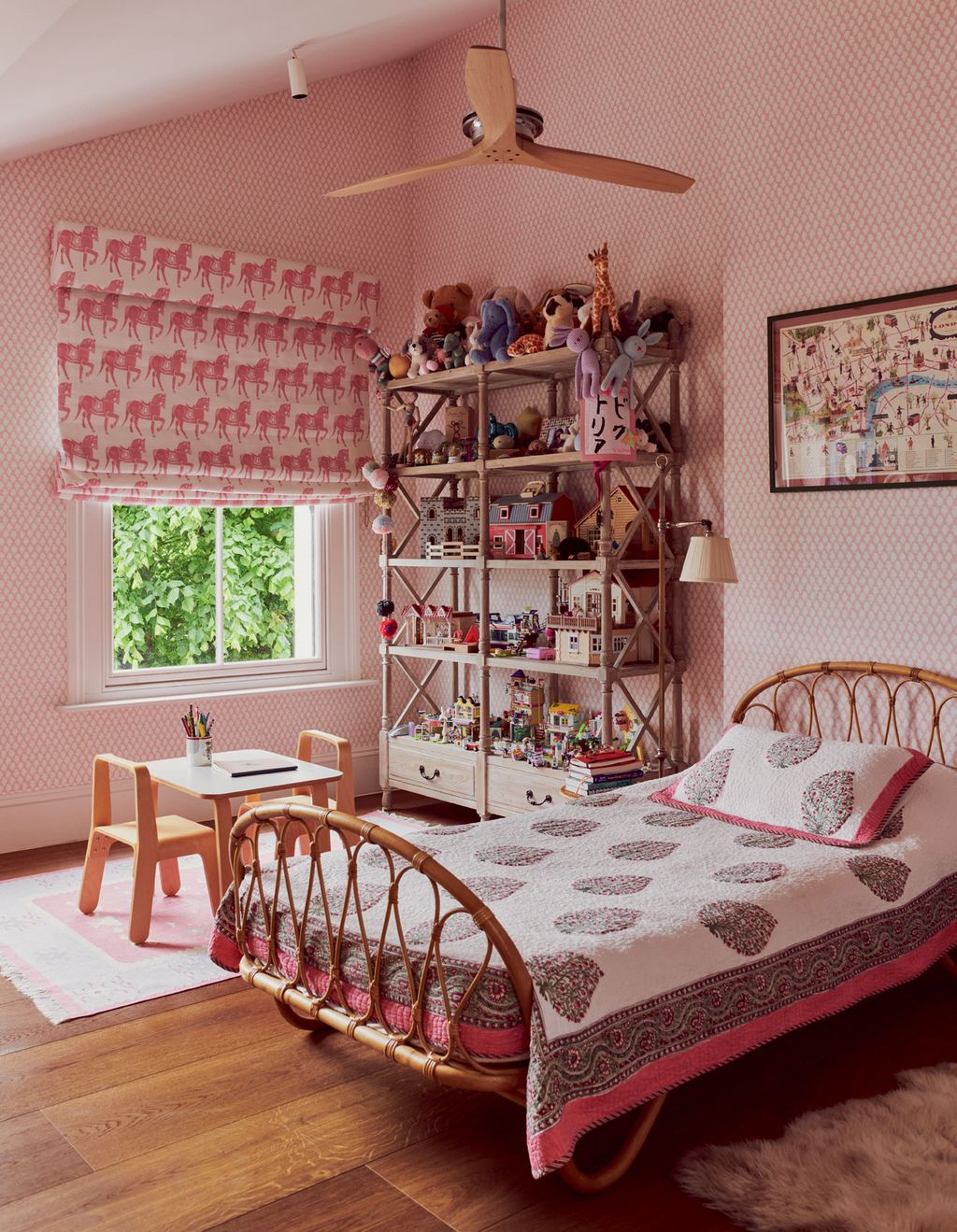 ‘Cherry Blossom wallpaper by John Stefanidis from Tissus dHlène provides a pretty backdrop for a rattan bed from Bon Ton.