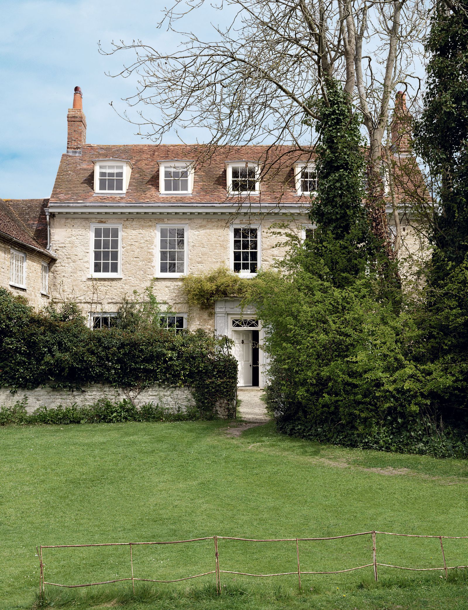 Image may contain Plant Grass Lawn Building Housing and Tree