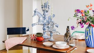 Image may contain Indoors Interior Design Wood Furniture Table Plant Hardwood Dining Table Flower and Ornament