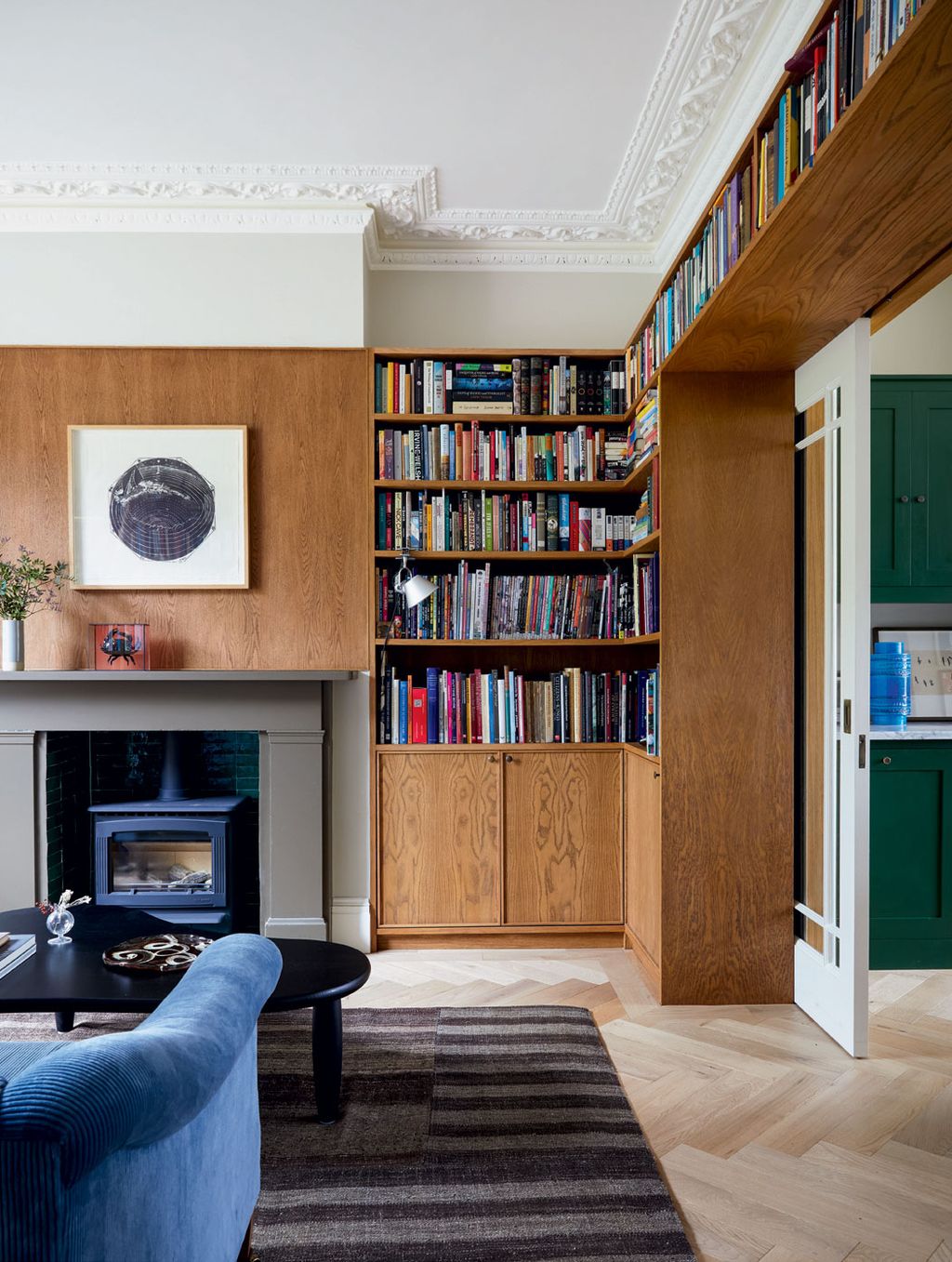 Image may contain Furniture Living Room Room Indoors Bookcase Interior Design Shelf Home Decor and Rug