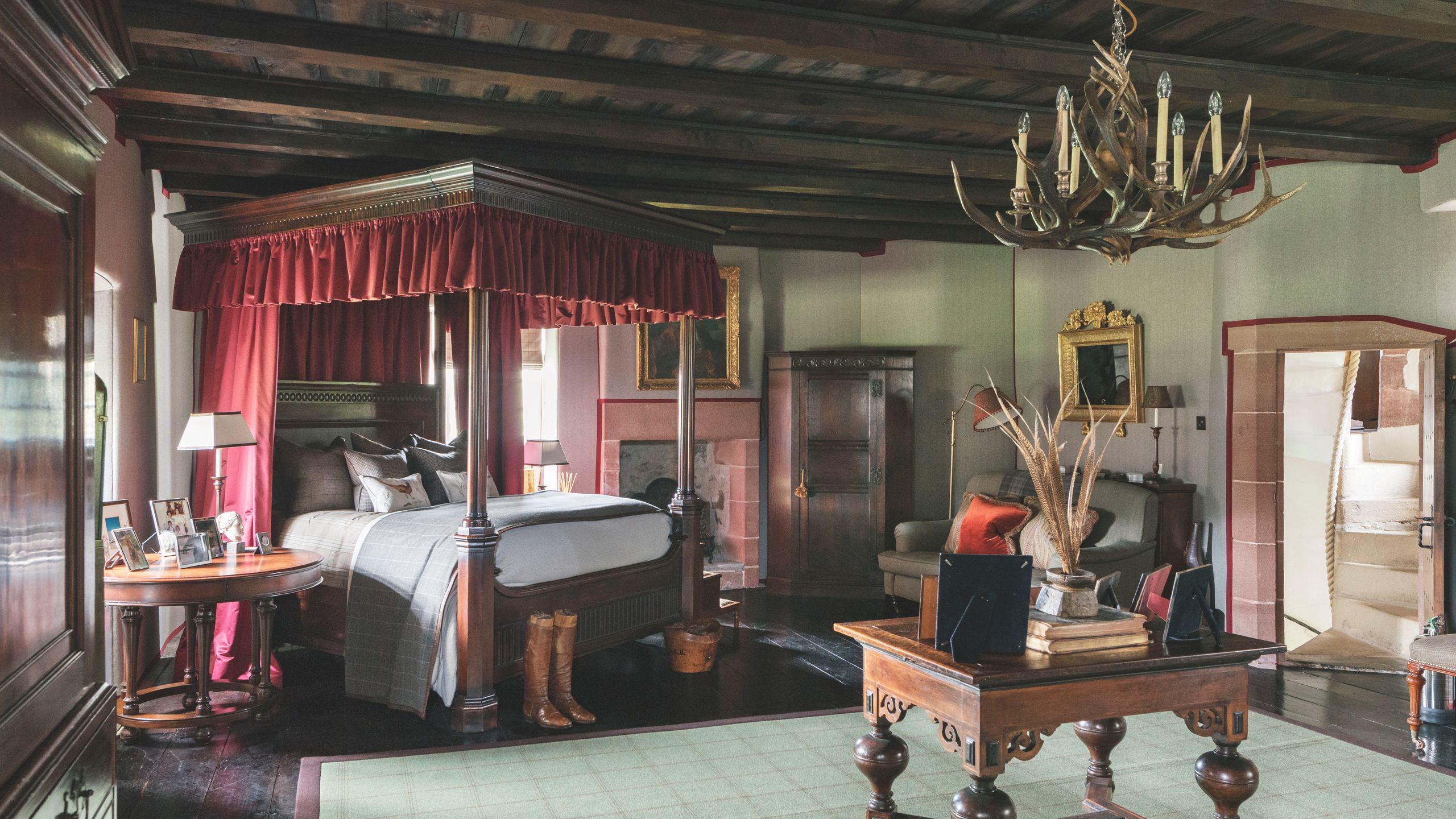 Image may contain Furniture Room Indoors Living Room Flooring Wood Bed Table Lamp Chandelier and Hardwood