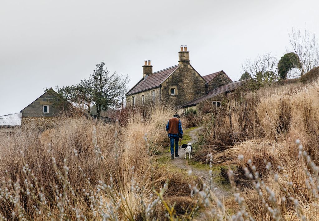 Image may contain Human Person Nature Outdoors Building Shelter Countryside Rural Animal Dog Mammal and Pet