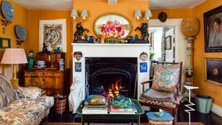 Image may contain Fireplace Indoors Furniture Living Room Room Cushion Pillow Interior Design Chair and Human