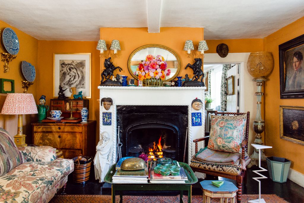 Image may contain Fireplace Indoors Furniture Living Room Room Cushion Pillow Interior Design Chair and Human