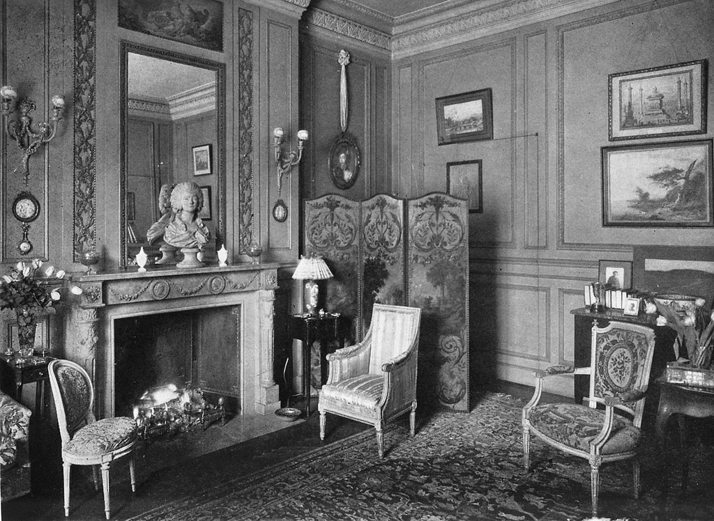 Image may contain Indoors Furniture Fireplace Living Room Room Human Person Hearth Chair and Interior Design