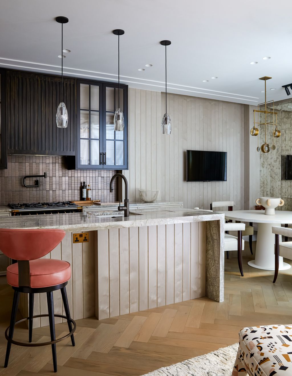 Image may contain Furniture Room Indoors Kitchen Interior Design Kitchen Island Living Room and Bar Stool