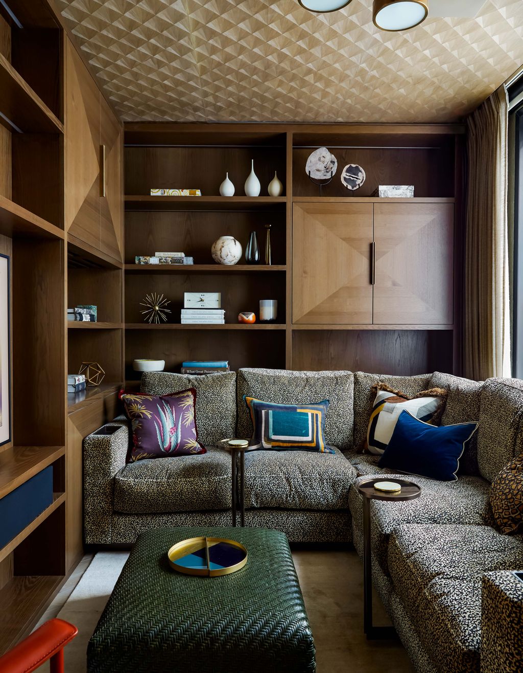 Image may contain Furniture Living Room Indoors Room Couch Shelf Interior Design Cushion Rug and Table