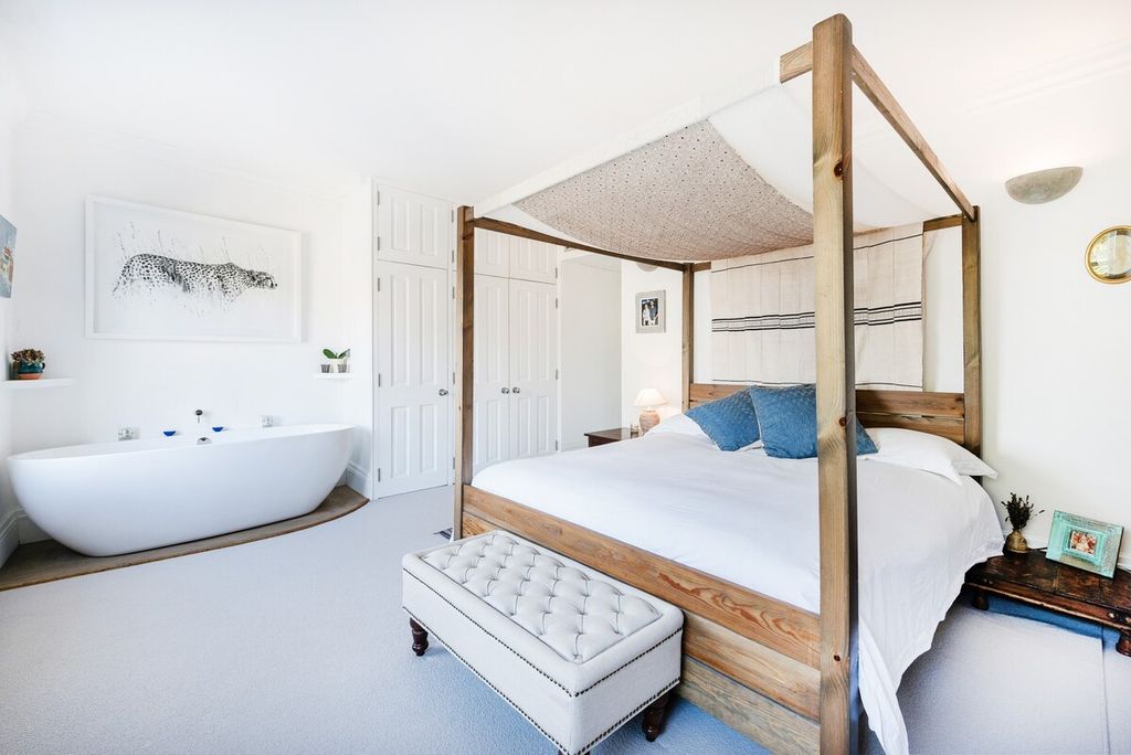 Image may contain Indoors Room Bedroom Tub Bathtub Building Housing Dorm Room Furniture and Bed