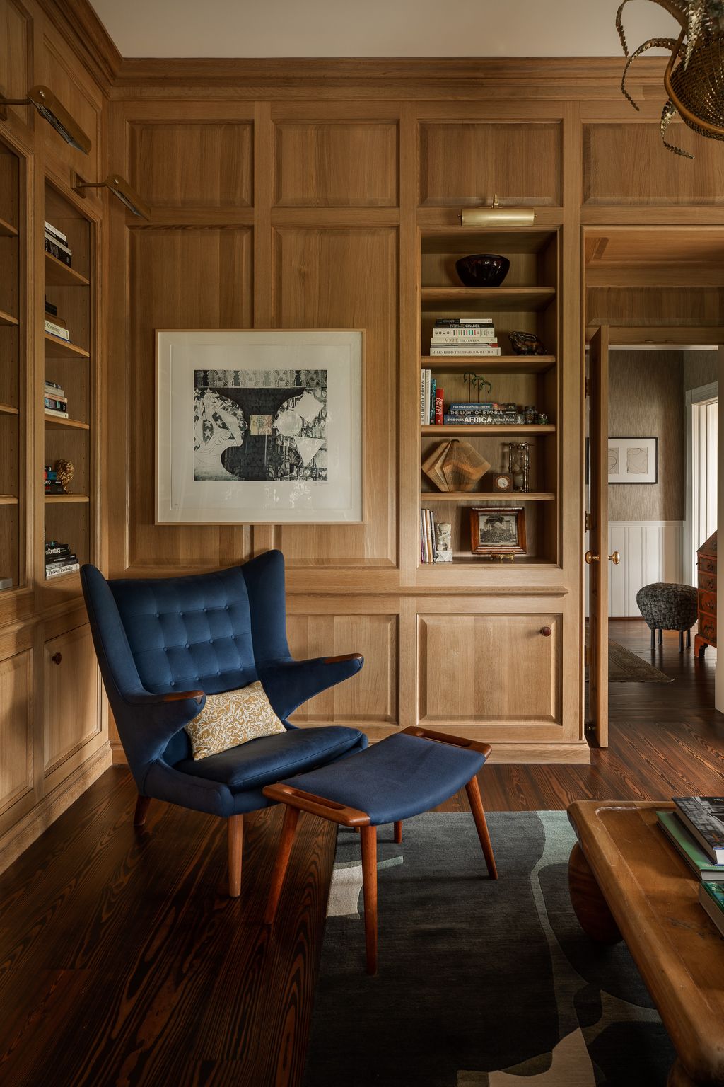 Image may contain Furniture Wood Hardwood Chair Shelf Living Room Room Indoors Flooring and Bookcase