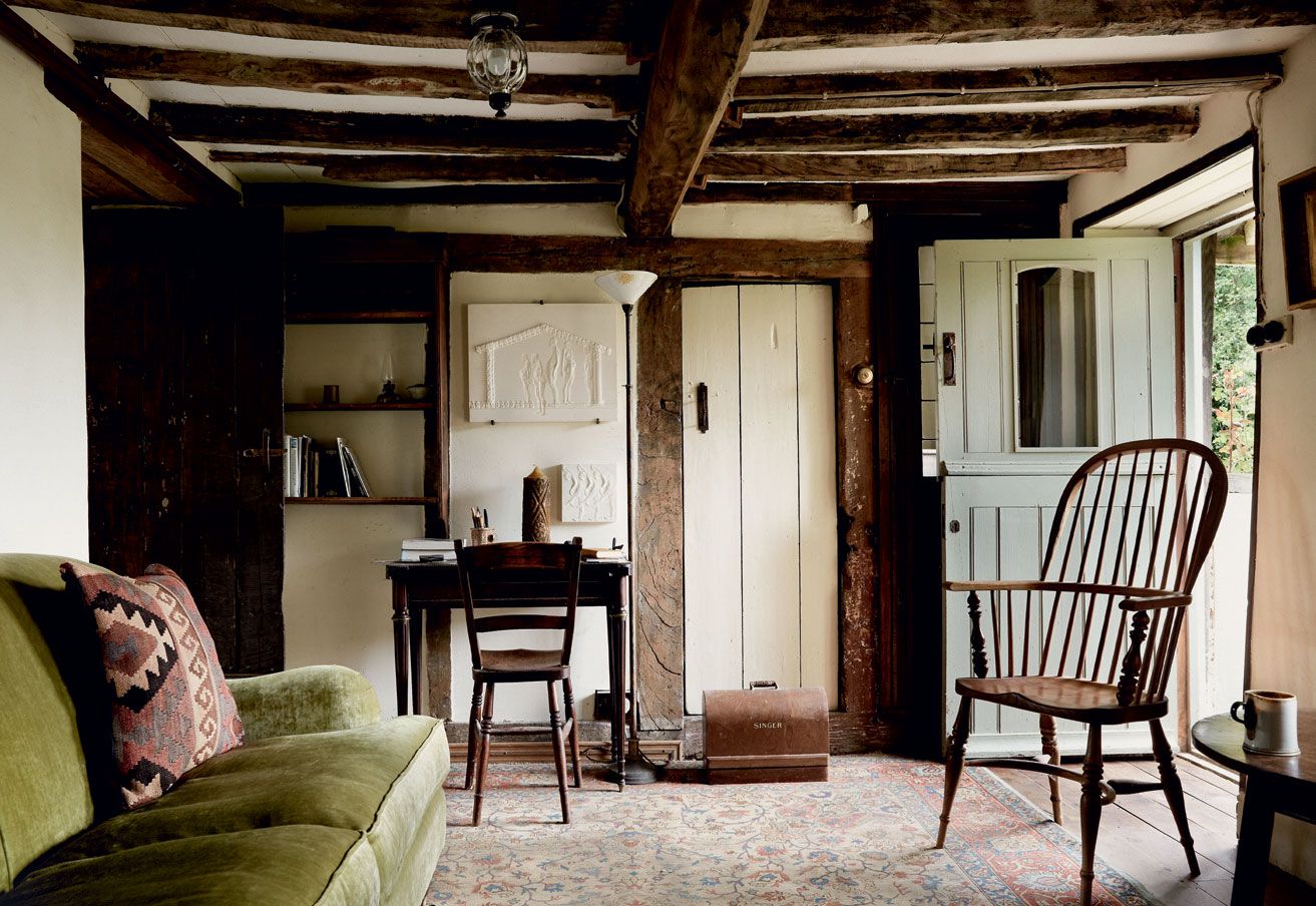 Image may contain Furniture Chair Living Room Room Indoors Wood Couch Interior Design Hardwood Flooring and Shelf