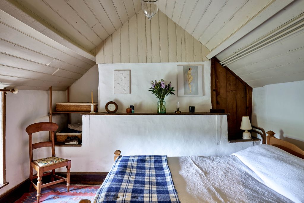 Image may contain Loft Housing Building Indoors Interior Design Attic Flooring Human Person Furniture and Plant