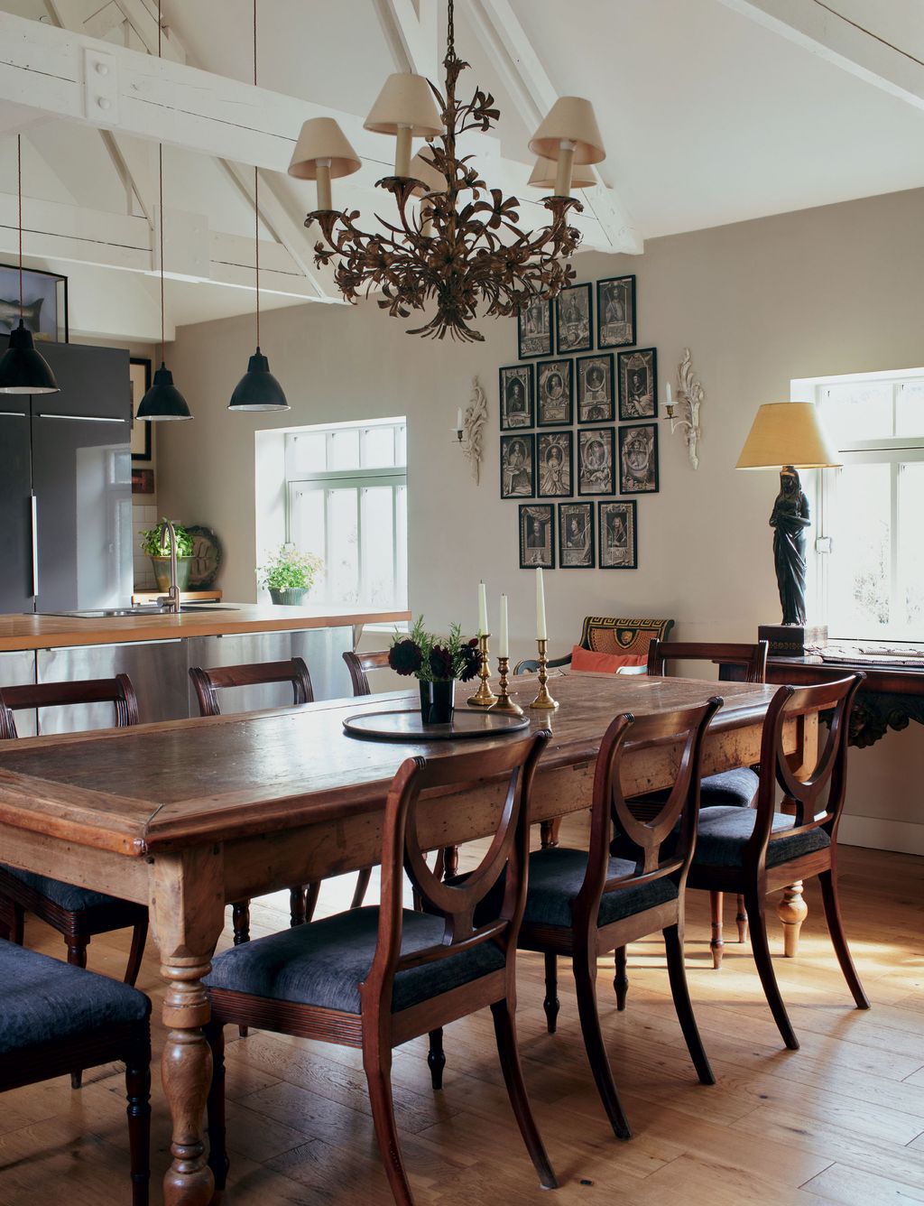 Image may contain Furniture Chair Room Indoors Wood Hardwood Dining Room Lamp Chandelier and Interior Design