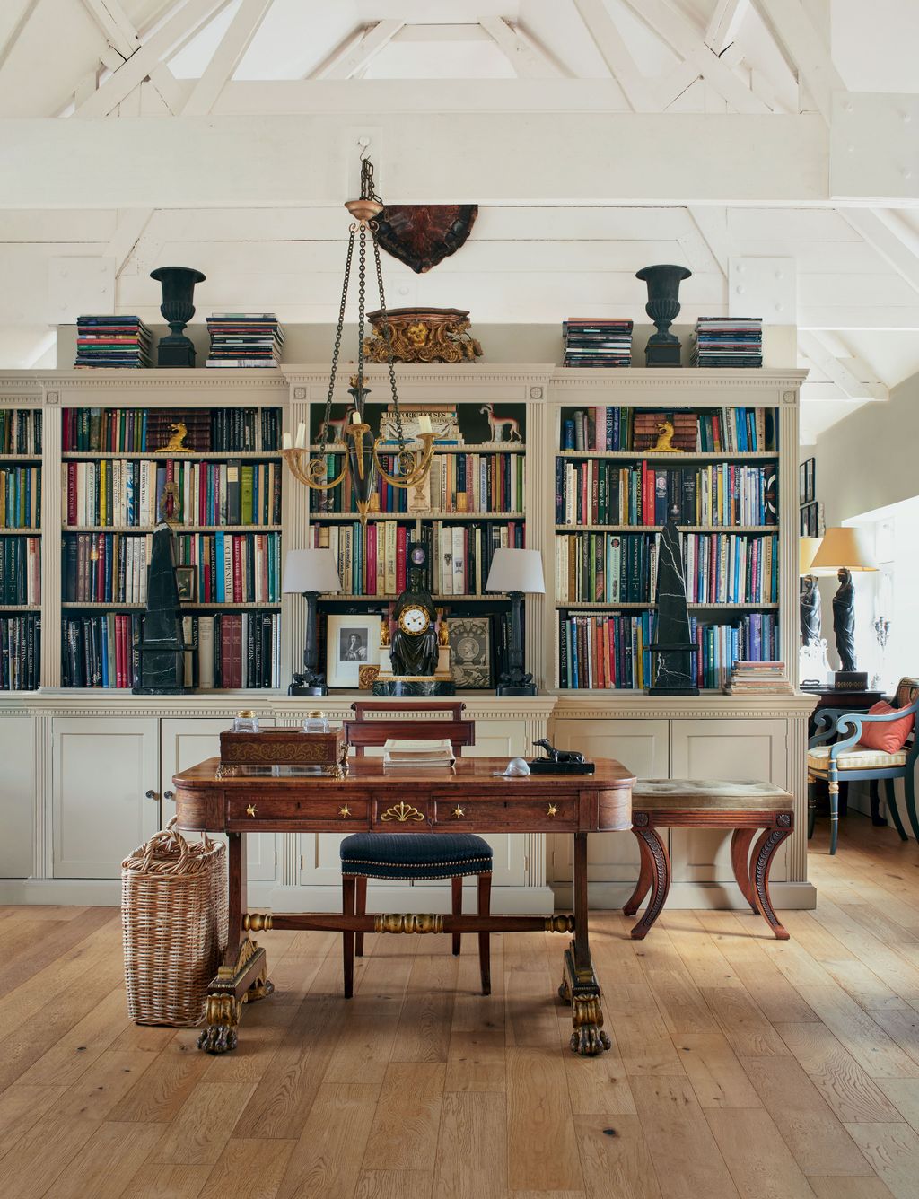 Image may contain Furniture Chair Bookcase Room Indoors Shelf Table Wood Living Room Flooring Human and Person