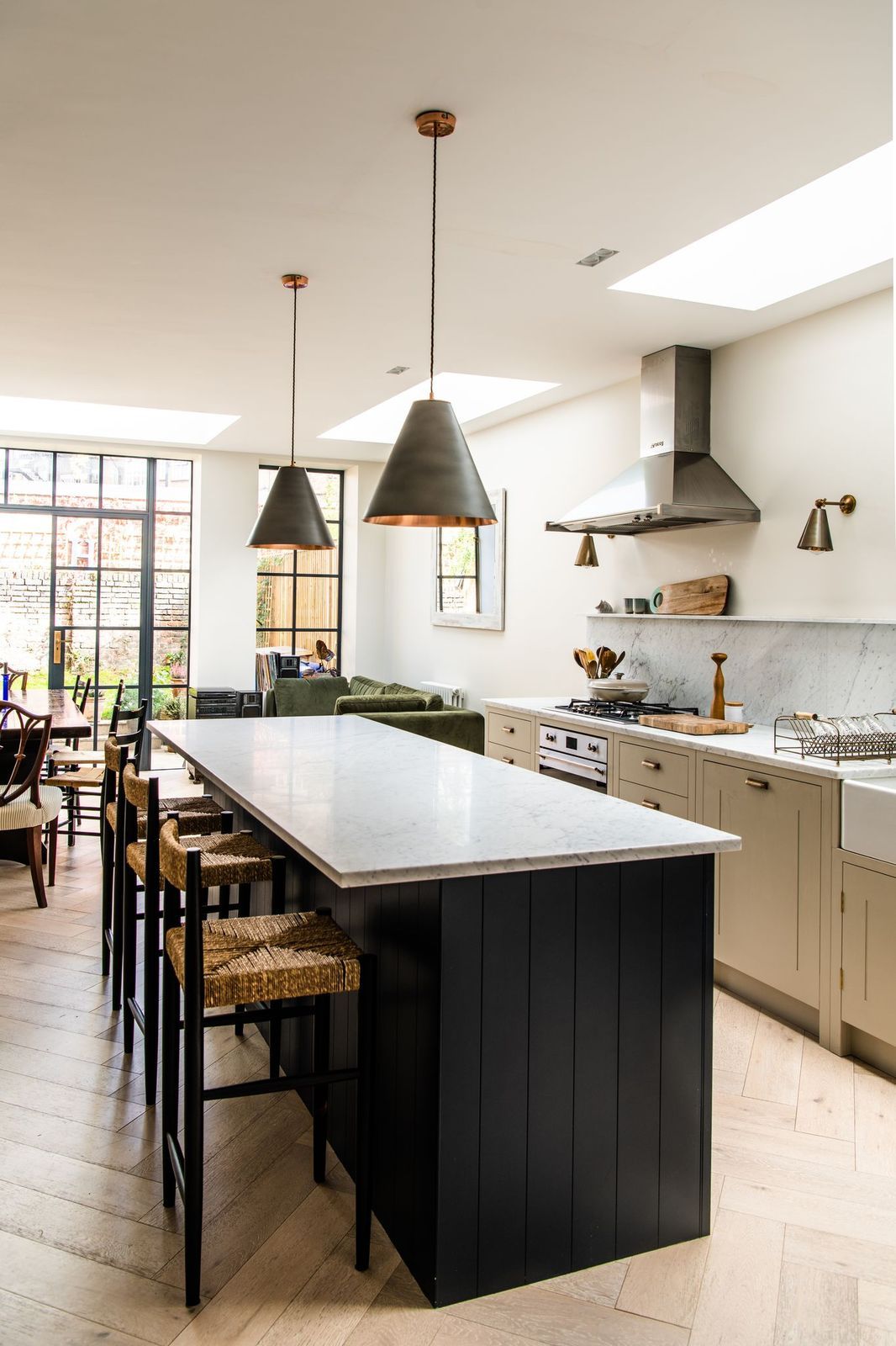 Image may contain Kitchen Island Indoors Room Human Person Interior Design Kitchen Furniture and Chair