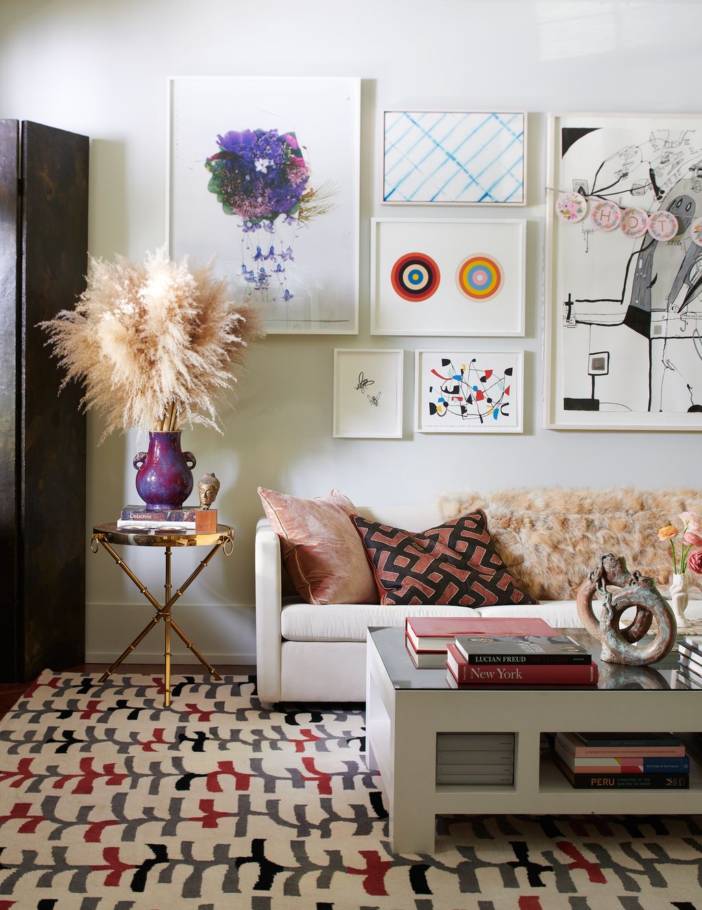 Image may contain Furniture Table Living Room Indoors Room Coffee Table Rug Interior Design Cushion and Couch