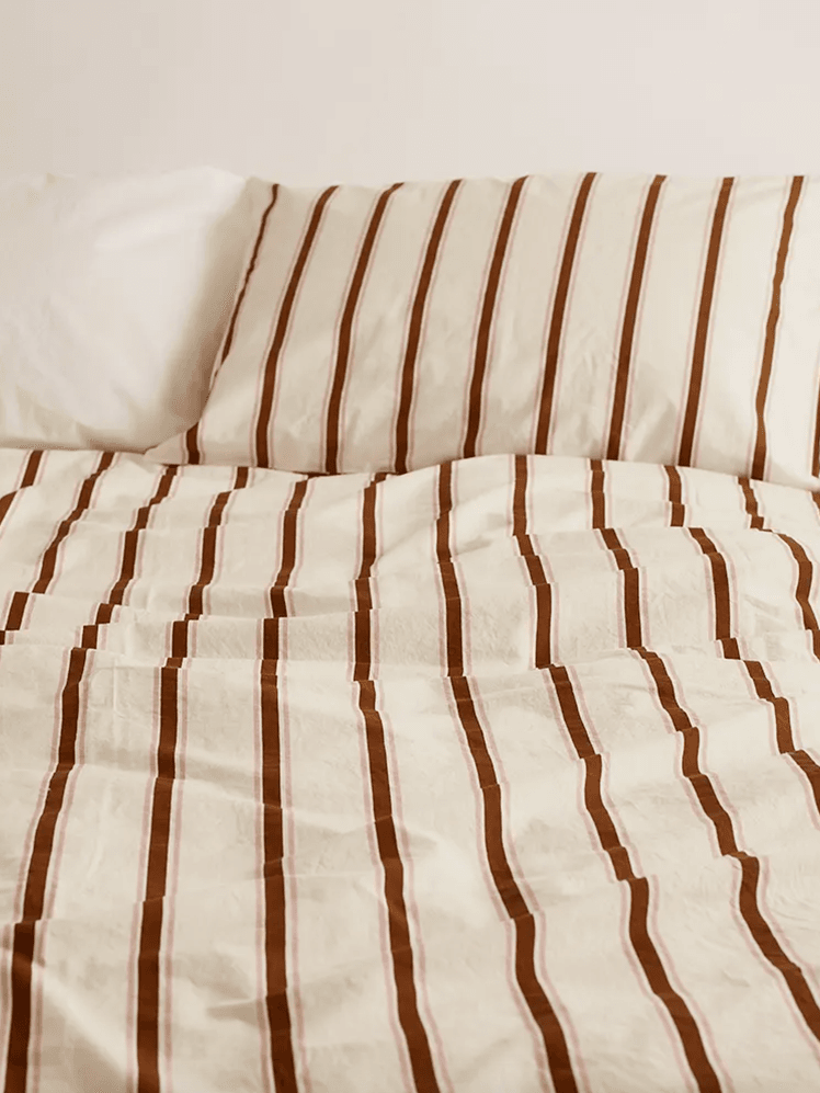 Image may contain: Home Decor, Cushion, Pillow, Lamp, Table Lamp, Furniture, Bed, Linen, and Rug