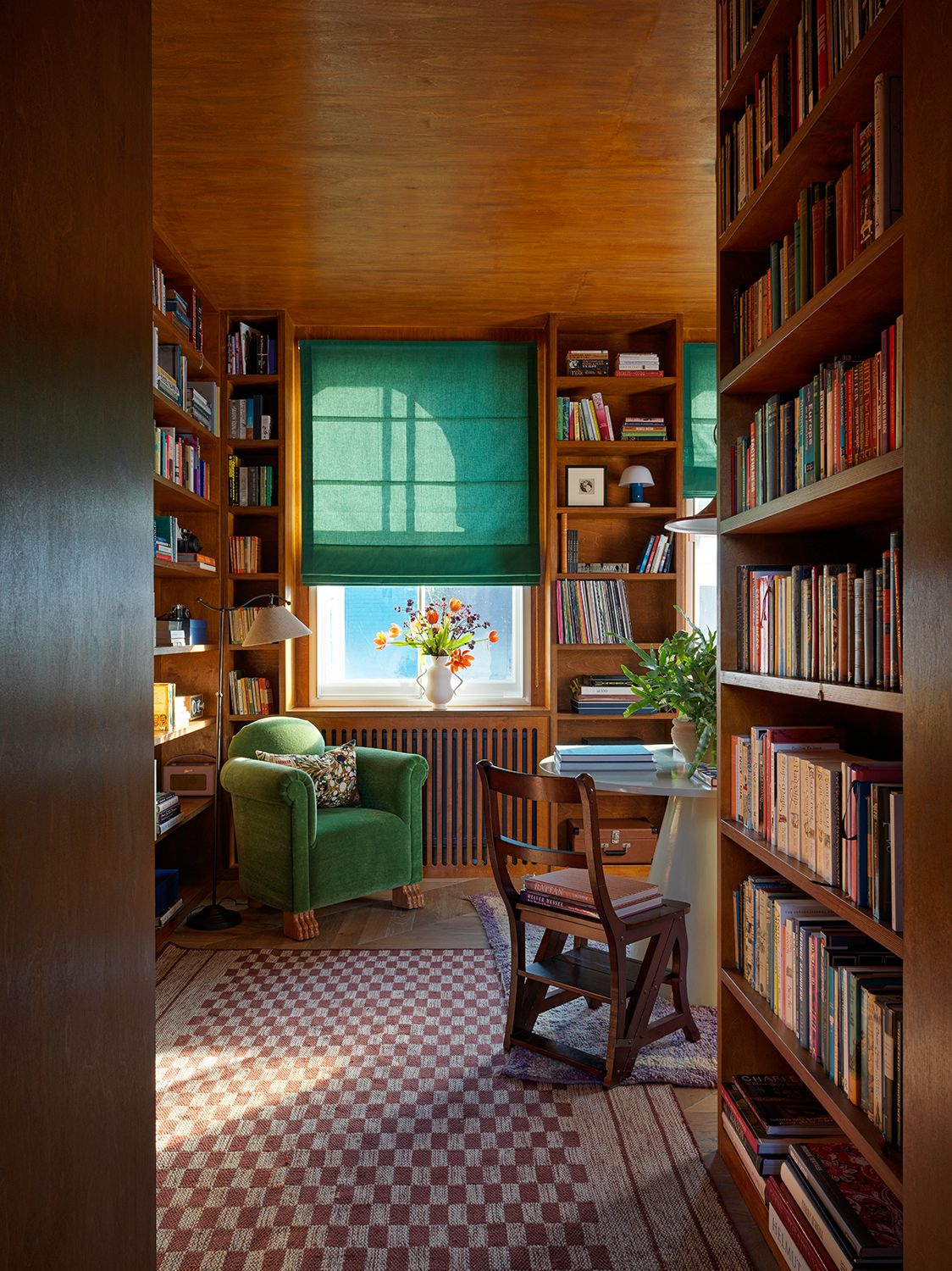 Image may contain Furniture Shelf Bookcase Home Decor Room Indoors Living Room Wood and Rug