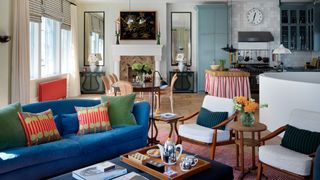 Image may contain Living Room Room Indoors Furniture Couch Table Coffee Table Interior Design and Clock Tower