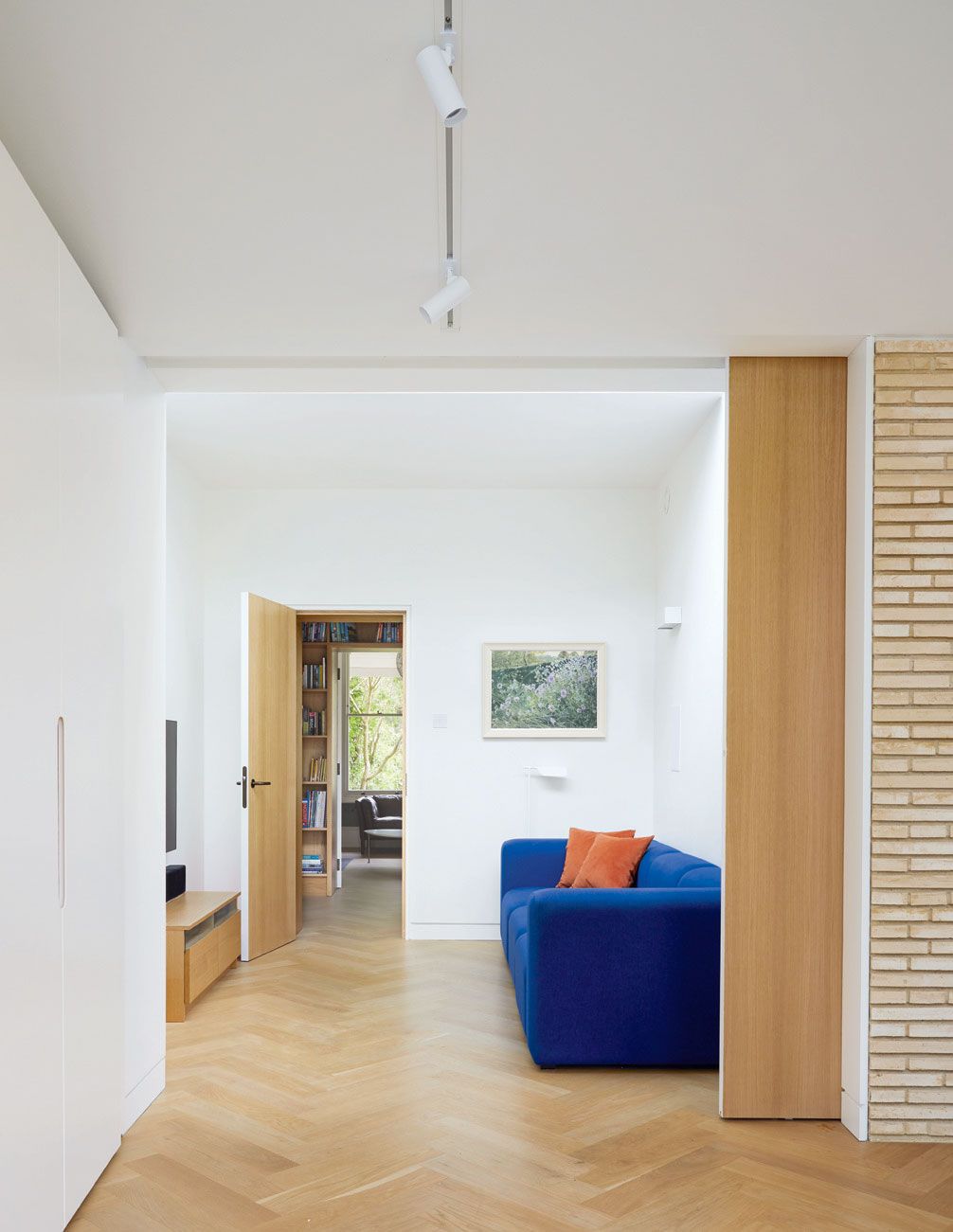 Image may contain Flooring Floor Interior Design Indoors Furniture Couch Living Room Room Wood Home Decor and Door