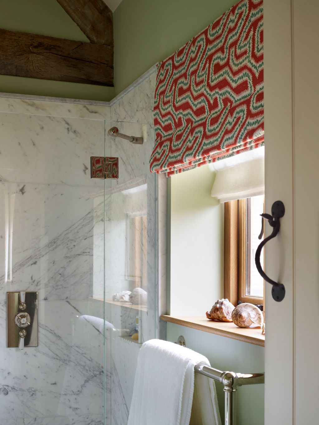 The Roman blind fabric is ‘Moorish Maze in Carmine by Rapture  Wright. The sheer blind fabric underneath is by Volga Linen.