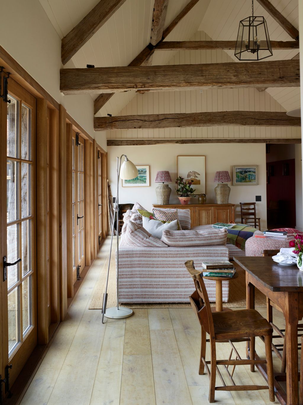 The sofa is covered in ‘Japura Coral by Christopher Farr Cloth. The task floor lamp is by Original BTC.