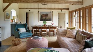 Image may contain Living Room Room Indoors Furniture Couch Interior Design Chair Wood Flooring Table and Hardwood