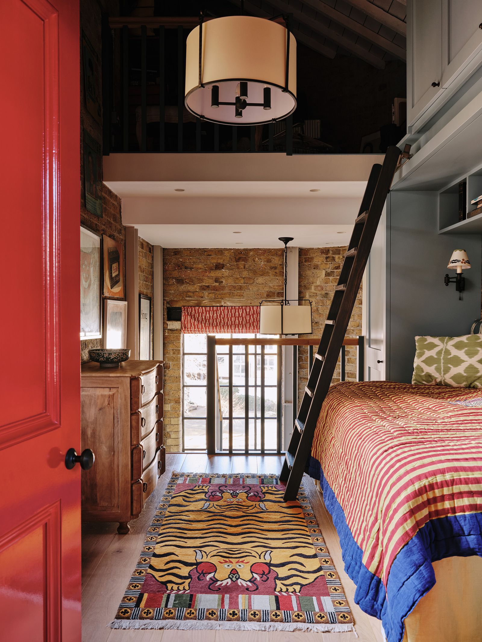 Image may contain Room Bedroom Indoors Interior Design Rug Housing Building Wood Furniture and Bed