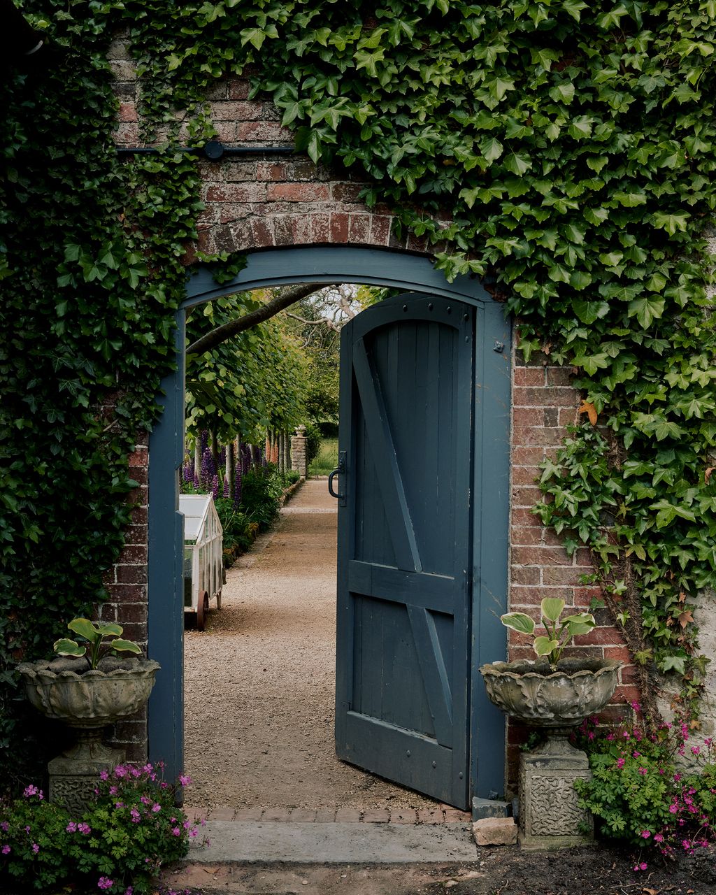 Image may contain Door Outdoors Plant Nature Building Shelter Countryside Rural Vase Pottery Potted Plant and Jar