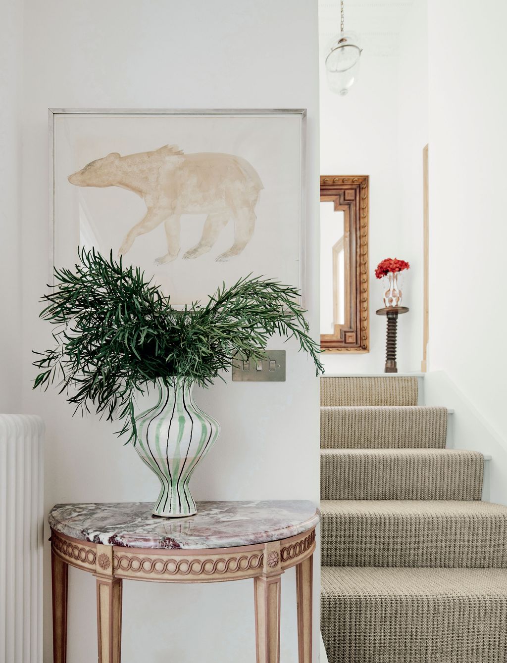 She inherited the marbletopped demilune table and she made the vase displayed on it herself. The drawing of the polar...