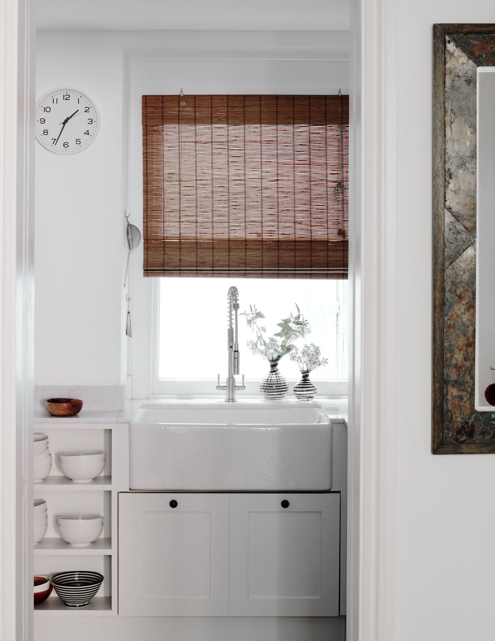 Pallas Kalamotusis uses a simple darkcoloured bamboo blind in her guest loocumutility room